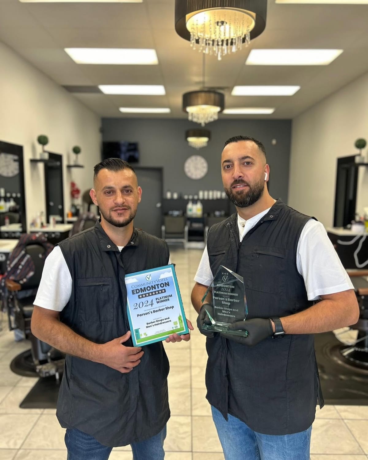 The Parsons Barber & Salon team inside the shop with their CommunityVotes Platinum Winner award
